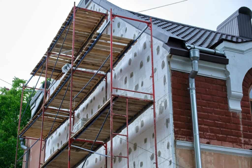 Construction scaffolding on house exterior during renovation process.