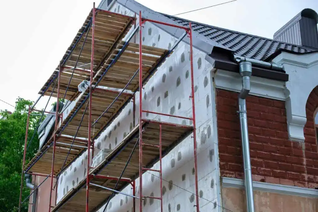 Construction scaffolding on house exterior during renovation process.