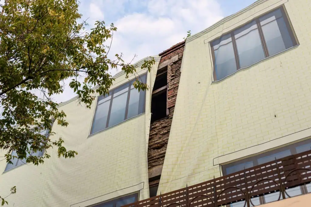 Contemporary house with large windows and a distinctive architectural feature.